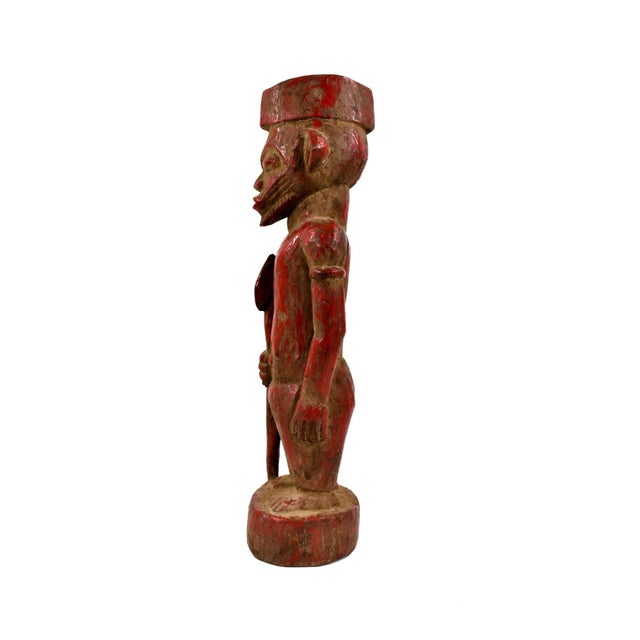 The Senufo Red Painted Standing Figure from CÃ´te d'Ivoire is a striking embodiment of Senufo artistic expression. Carved...