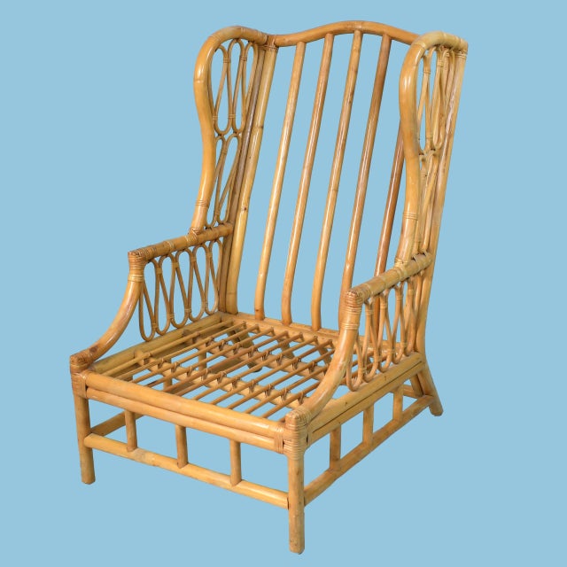 Sink into comfort with this pair of bent rattan wingback chairs. Gracefully curved rattan frames and tall wingback...