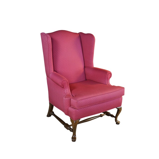 This elegant Queen Anne wingback armchair features a classic high, arched backrest flanked by sweeping wings and...