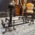 Design Plus Gallery presents a Pair of Andirons and Fender for the Fireplace. They have an oil rubbed tone to their metal...
