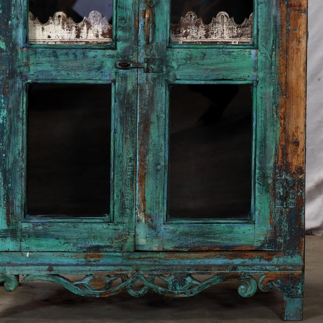 Antique Indian Painted Cabinet, with a scalloped top gallery and pierced lower apron, and a scalloped interior shelf...