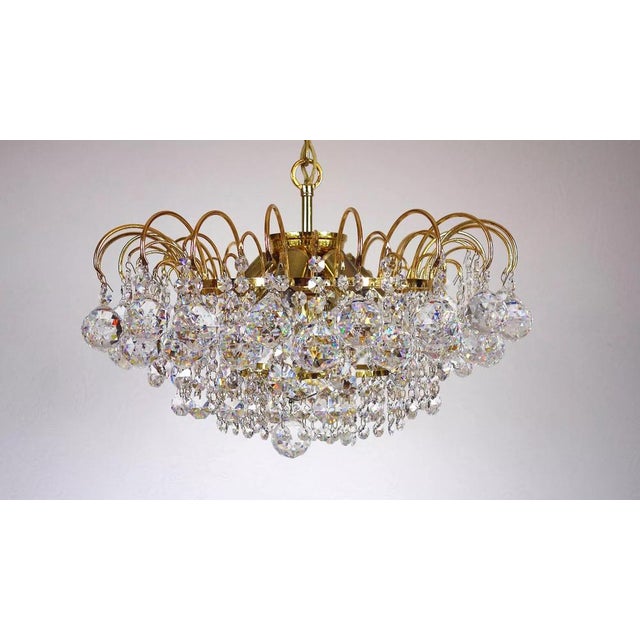 Brass & Lead Crystal Chandelier from Palwa, in Very Good conditions. Designed 1970 to 1979 This piece has an attribution...