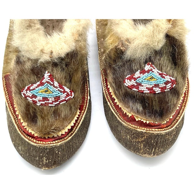 Pair of 20th Century Navajo Beaded Moccasins This exquisite pair of 20th-century Navajo beaded moccasins is a fine example...