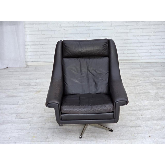 1960s, Danish highback swivel armchair by Aage Christensen. Original dark brown furniture leather, chrome steel. Original...