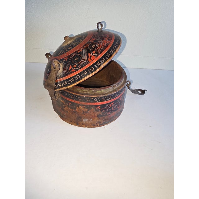 Interesting red and black round spice storage box from India.