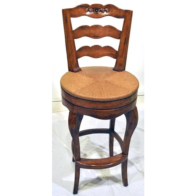 These Great ladderback bar or counter stools feature woven rush seats and swivel to make for easy conversation. Crafted by...