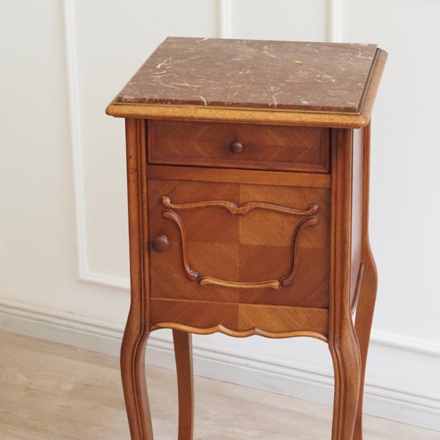 French bedside table in the louis xv style, likely made around 1900 during the historicist revival of the rococo. The...