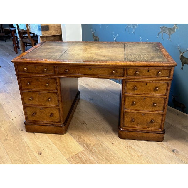 A beautiful, pure antique burl walnut desk with a leather top. It is in perfect, original condition. It has a wonderfully...