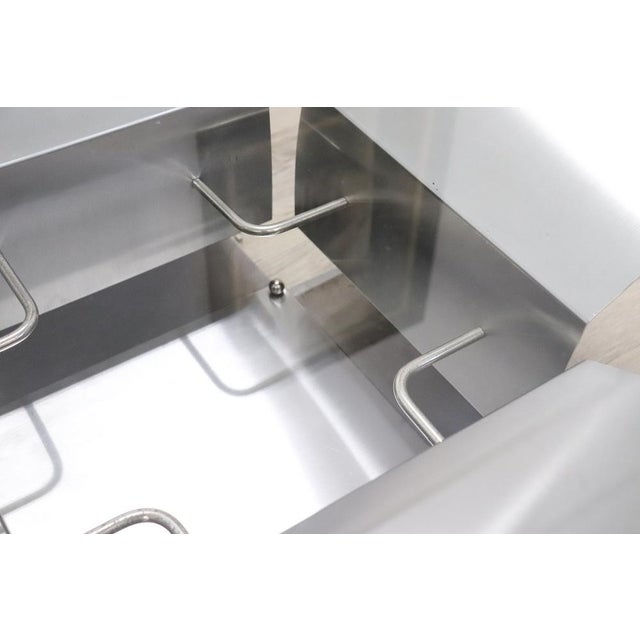 This is a beautiful and sophisticated piece of 20th-century furniture. The table features a frame composed of four...