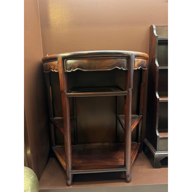 A beautifully preserved pair of Qing Dynasty Chinese rosewood tables, executed in an elegant half-round form that allows...