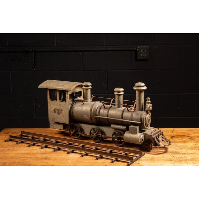 c. 1900s Antique 2-6-0 steam locomotive model with "717" applique. This piece is constructed of galvanized steel with...