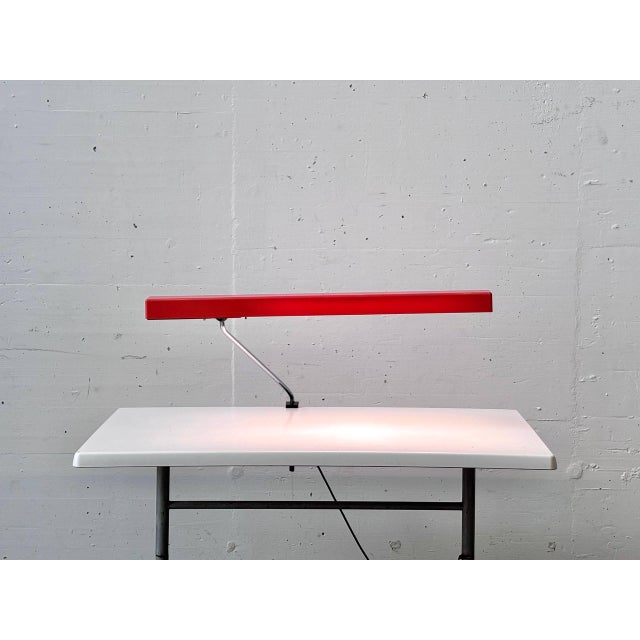 A striking clamp lamp from aeg dating back to the 1970s, featuring a clean, functionalist design. The elongated...