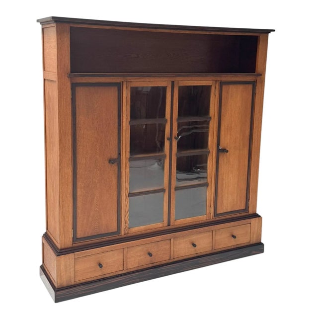 Magnificent and rare Art Deco Modernist four-door bookcase. Striking Dutch design from the 1920s. Solid oak base with...