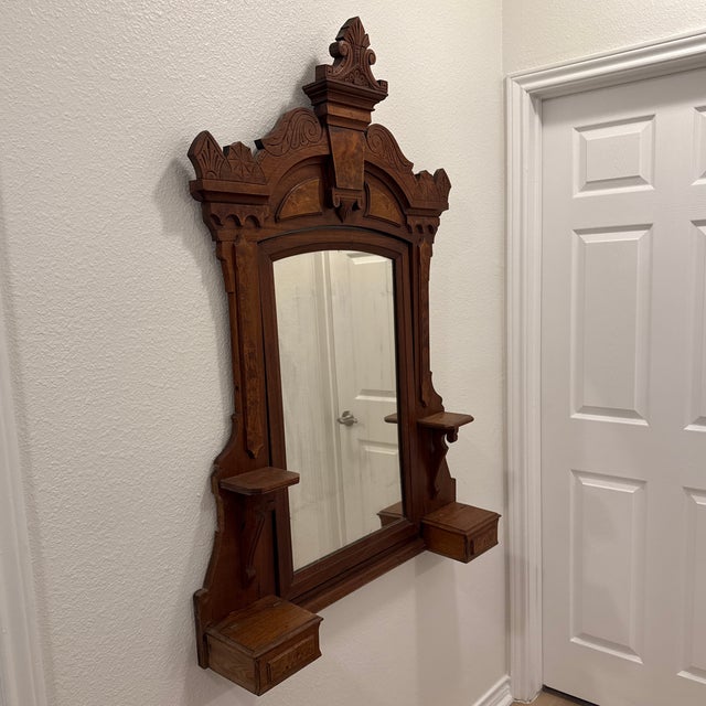 Stunning and rare 19th-century hand-carved wall mirror in the Eastlake or Victorian Gothic style, likely made of solid...