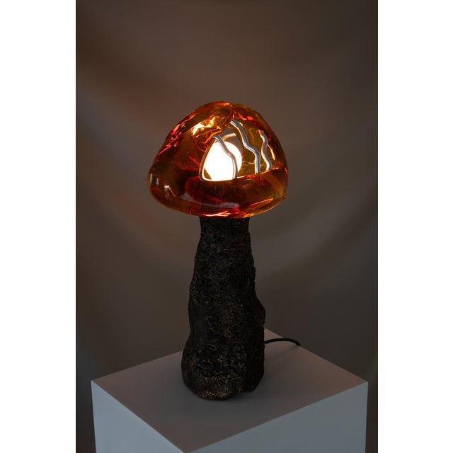 Somehow Honey Dreams Of Fire consists of two handcrafted table lamps. The solid glass lampshades are crafted by French...
