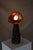 Somehow Honey Dreams Of Fire consists of two handcrafted table lamps. The solid glass lampshades are crafted by French...