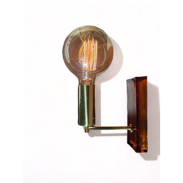 Vintage amber glass wall lamps | denmark, c. 1970s danish wall-mounted lighting in brass and sculptural amber glass...