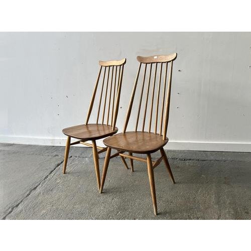 A pair of vintage Mid-century1960’s Ercol Goldsmith chairs in elm and beech. Designed by Ercol founder Lucian Ercolani....
