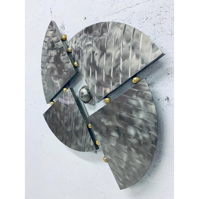 Metal wall sculpture with brass accents from the Mid 90s. Unsigned.