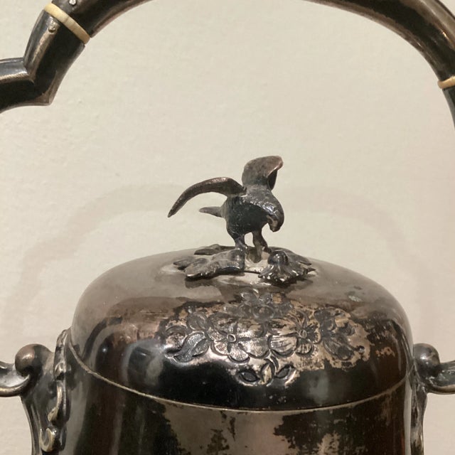An ornate Victorian silver plate tea kettle with original three trefoil decorative footed burner. Circa 1880s Late...