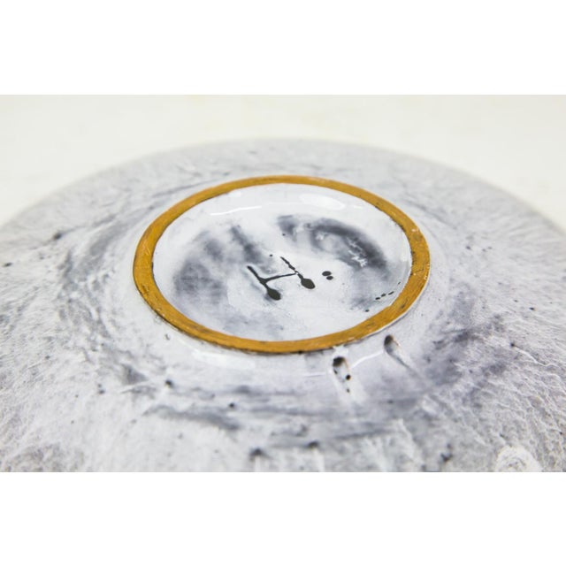 This striking vintage wall plate was designed by the renowned Hungarian ceramicist Ilona Benkő during the 1970s. The piece...