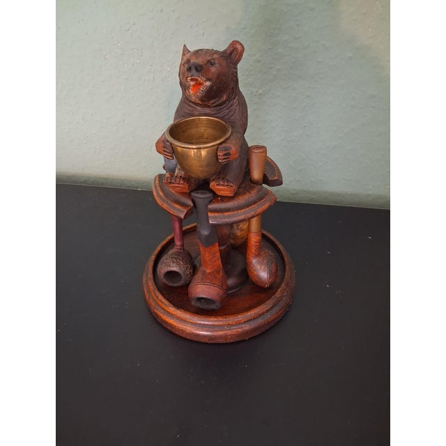 This pipe holder with a bear is a product of England, a bear stander with a brass ashtray on hands, which holds 4 pipes....