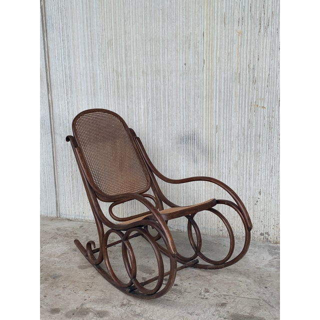 About Midcentury elegant rattan rocking chair in the Thonet style. It is very comfortable and very inclined like a chaise...