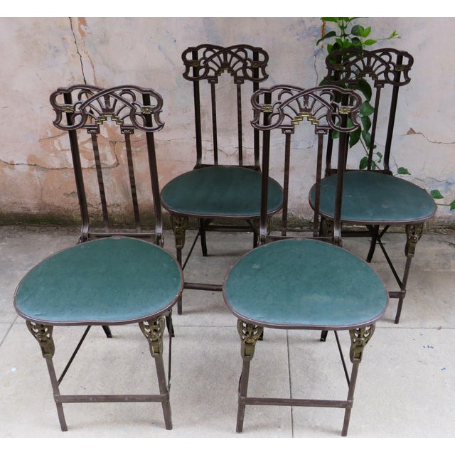 Early 20th century Art Nouveau cast iron set with a folding table and four matching chairs. Each chair has been covered...