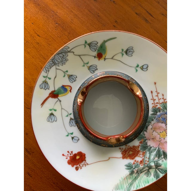 Beautifully colored and designed Asian ashtray in near perfect condition. The raised center edge has a gold rim and a...