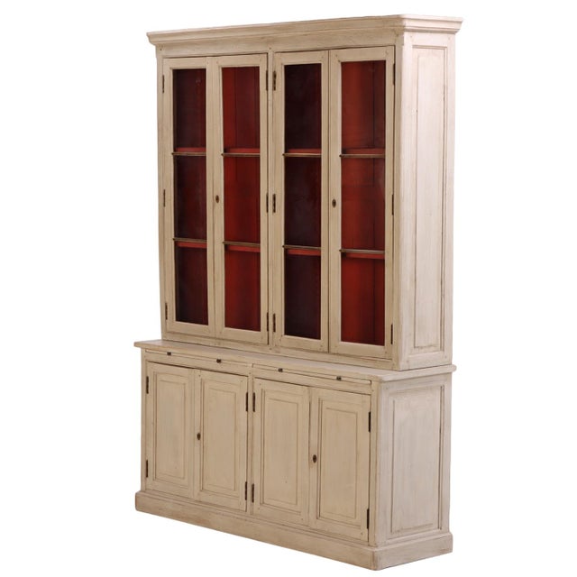 This 19th-century two-piece cabinet bookcase has a simple, traditional form with a softly painted, timeworn finish. The...