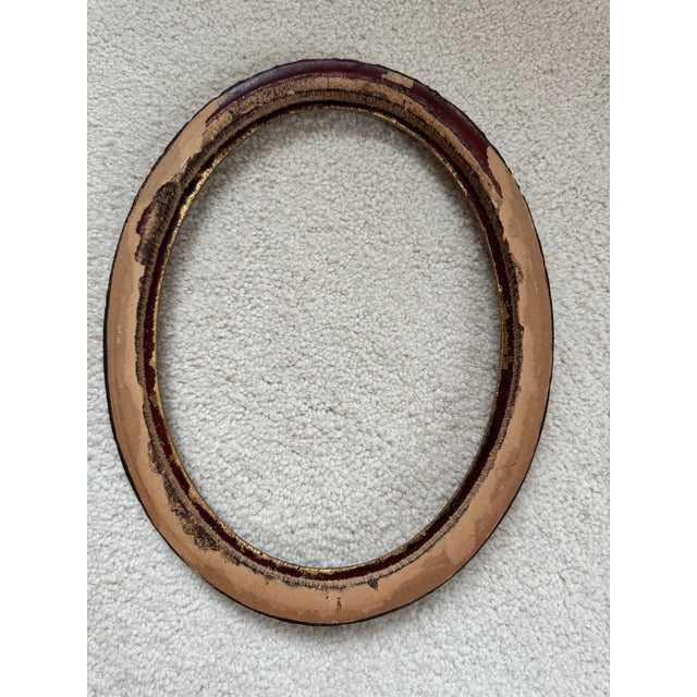 Add a touch of Old World European elegance to your space with this beautifully ornate oval frame. Featuring a warm antique...