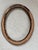 Add a touch of Old World European elegance to your space with this beautifully ornate oval frame. Featuring a warm antique...