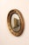 An American carved-wood bullseye accent mirror in black and bronze/gold, from the 19th century. This antique mirror...