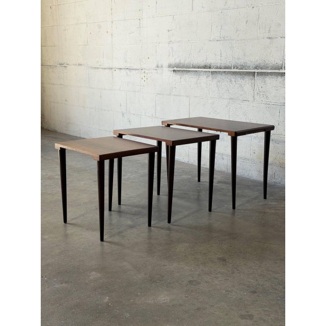 This elegant set of three nesting tables features a clean and highly functional minimalist silhouette. The graduated...