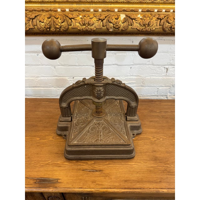 A beautifully detailed late 19th-century French book press, crafted from solid cast iron with elegant decorative motifs....