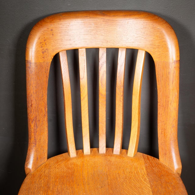 ABOUT Contact us for a customized shipping quote. Antique solid oak banker's or library chair, often referred to as a...