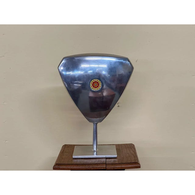 Aluminum sculpture with a colorful round glass insert on the front and back center. The glass discs are painted with small...