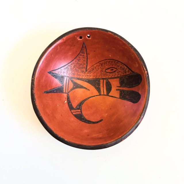 A vintage Native American pottery small bowl by Hopi artist, Vivian Muchvo. Made of red earthenware clay with a hand...