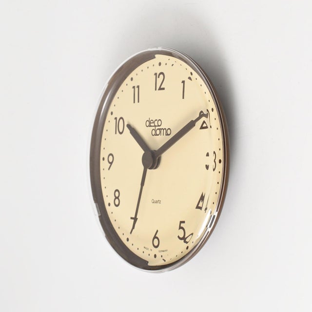 New old stock quartz clock made of brown plastic. It can be used as a wall or desk/table clock. Quartz movement uses one...