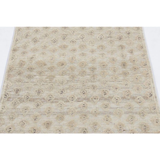 Hand-knotted in a luxurious blend of wool and silk, this 3x8 runner rug is a radiant and sophisticated addition to the Rug...