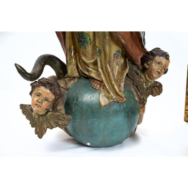 An antique Neapolitan polychrome wood sculpture depicting the Immaculate Virgin Mary, dating from the 18th century. The...