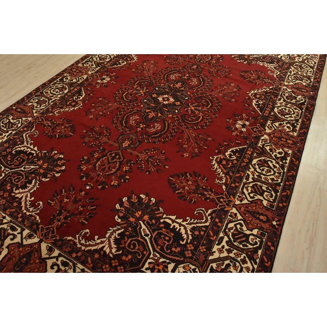 An authentic vintage traditional Baloch rug hand-knotted with fine wool and natural dyes. This rug features a central...