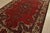An authentic vintage traditional Baloch rug hand-knotted with fine wool and natural dyes. This rug features a central...