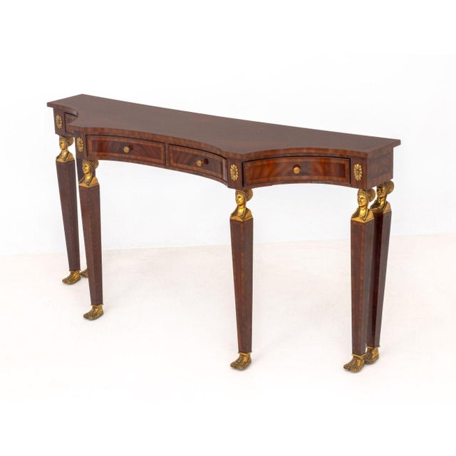 Egyptian Revival Brass Mounted Mahogany Console Table, with four drawers above six caryatid supports. 34.5" H x 67" W x...