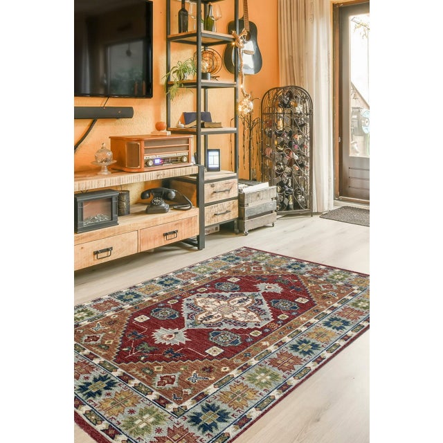 Sophie Chic Red Hand Knotted Wool Rug, Country of Origin: India. This striking piece presents a compelling fusion of...
