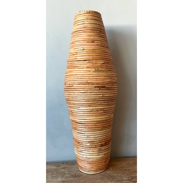 Infuse your home with organic texture and coastal elegance with this stunning vintage pencil reed floor vase. Expertly...