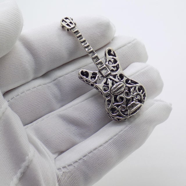 Charming vintage electric guitar miniature, handcrafted in italy during the 1980s to 1990s in genuine continental silver...