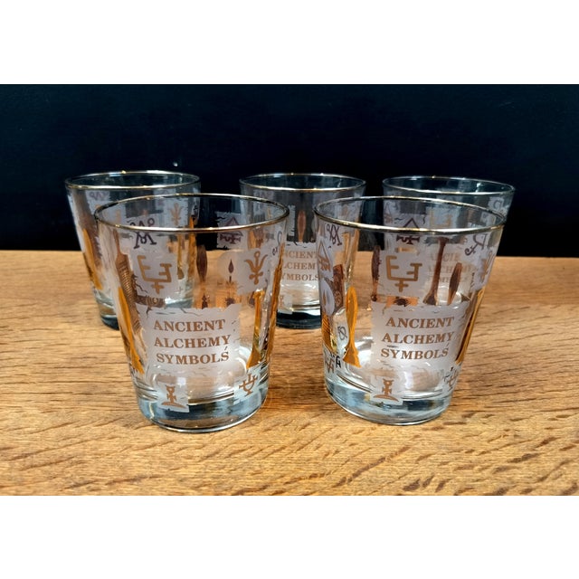 Set of 5 1960's Alchemy themed tumbler glasses. Gold on frost style all over print of alchemical symbols. In very good...