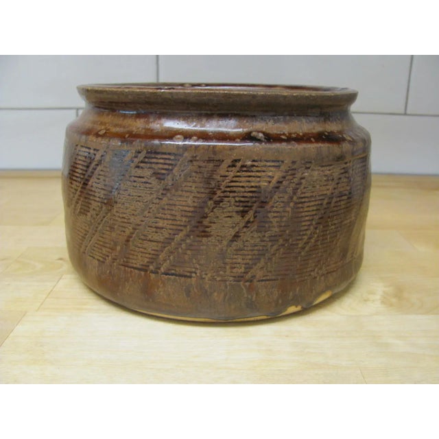 Very fine, large bowl by Warren McKenzie. Brown Shino glaze with exterior designs. Marked on the outer bottom edge with...