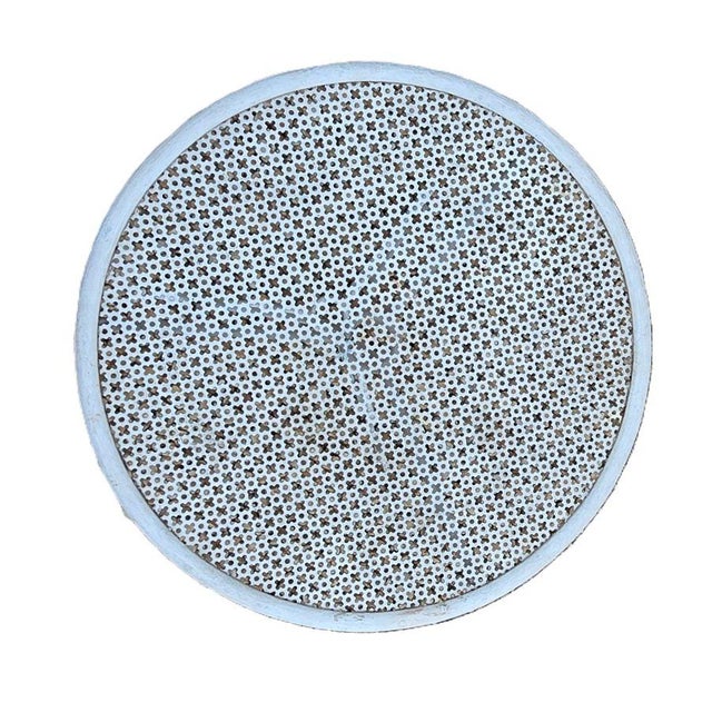 Charming small round tripod side table in perforated and white lacquered wrought iron. The tabletop is perforated with a...
